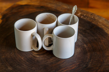 four coffee cups in wooden table