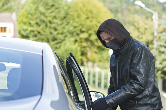 Thief stealing a car
