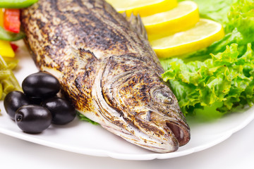 Grilled fish with vegetables.