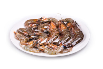 Raw shrimps on white plate.