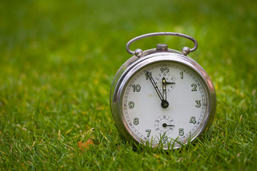 Clock on a green grass