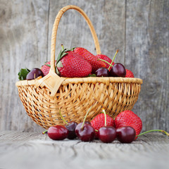 Fototapeta na wymiar Basket with strawberries and cherries