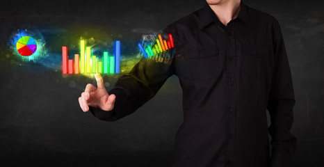 Handsome young business man touching colorful modern graph syste