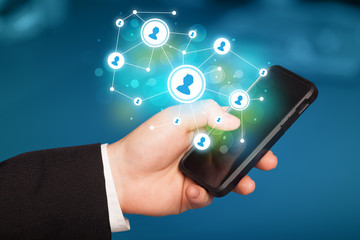 Finger pointing on smartphone, social network concept