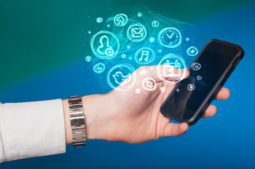 Hand holding smartphone with mobile app choices