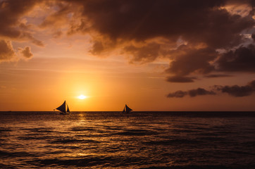 Silhouette of sailing boats against a beautiful sunset