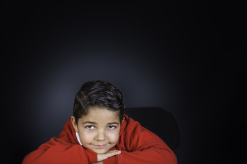 A young boy laying his head on his arms