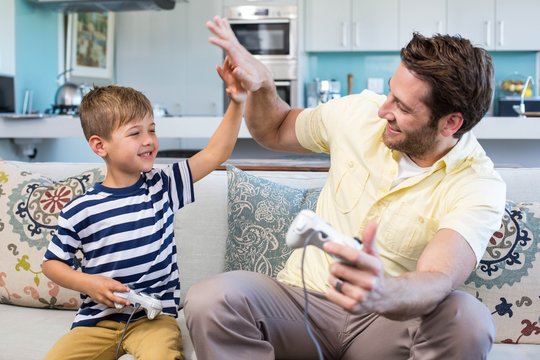 Father And Son Playing Video Games Together