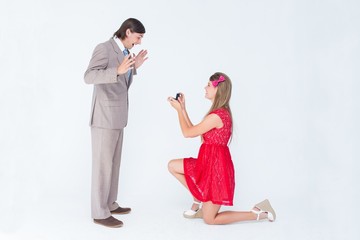 Pretty hipster on bended knee doing a marriage proposal