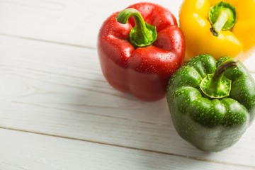 Three peppers on chopping board