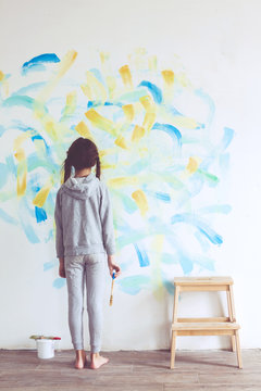 Child painting wall