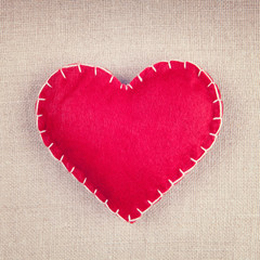 Naklejka na ściany i meble Red heart on vintage fabric background