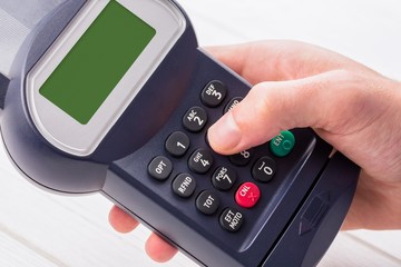 Obraz premium Man entering his pin on terminal