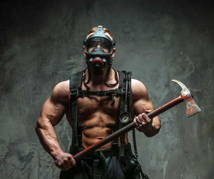 Muscular firefighter with axe