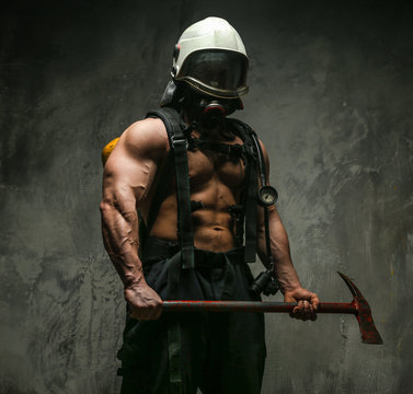 Muscular firefighter with axe