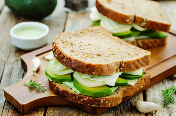 sandwiches with avocado, cheese, cabbage and cheese and herb top