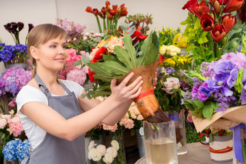 Florist puts bouquet into the vase