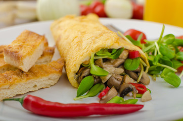 Omelette stuffed with mushrooms and microgreens