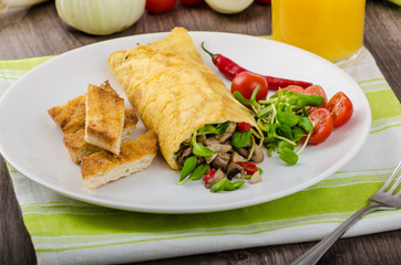 Omelette stuffed with mushrooms and microgreens