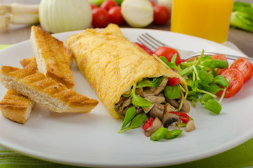 Omelette stuffed with mushrooms and microgreens
