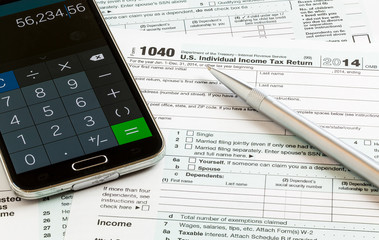 Pen and smartphone on 2014 form 1040
