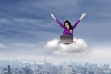 Fototapeta na wymiar Cheerful student with laptop on cloud