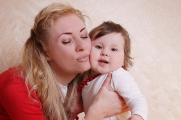 Mother cheek to cheek with one year baby girl