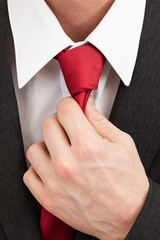 Businessman grabbing tie