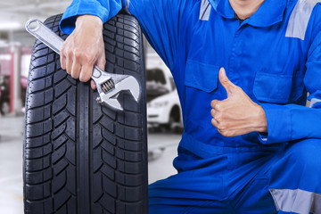 Male mechanic showing thumb up in workshop