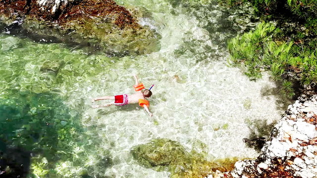Little boy snuckering in the warm Adriatic sea waves
