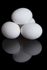 chicken eggs on a black background