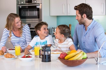 Happy family having breakfast together