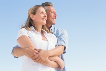 Happy couple standing and hugging