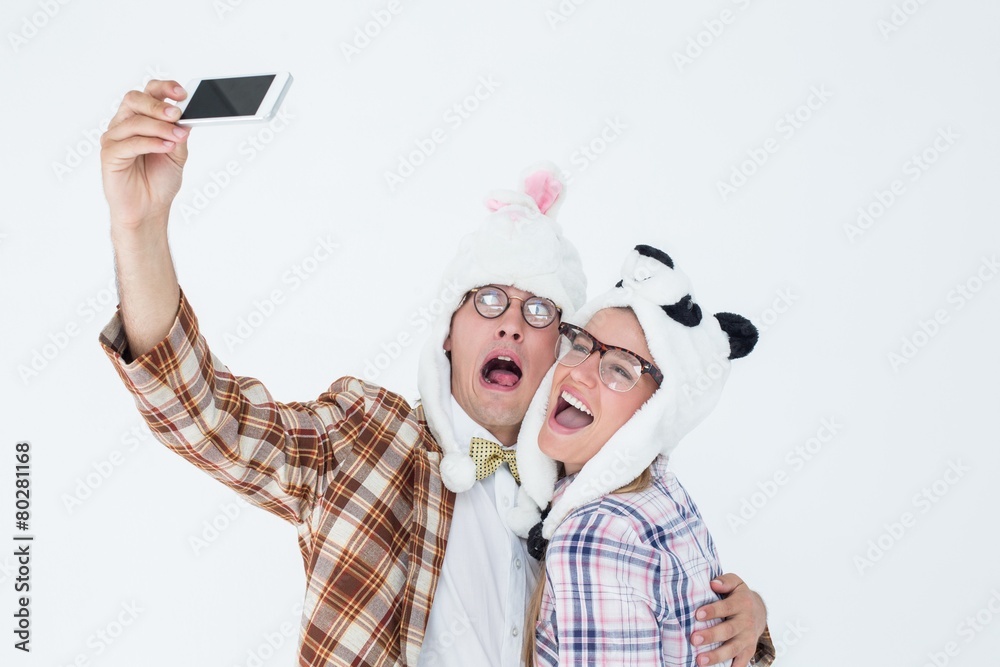 Poster geeky hipster couple taking selfie with smart phone