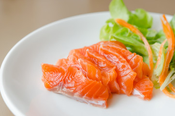Salmon sashimi with fresh salad