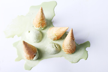 green tea ice cream cones dropped upside down