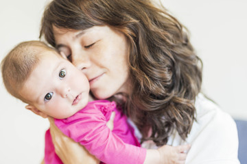 Family Concept: Portrait of Young Mother Taking Care of Her Litt