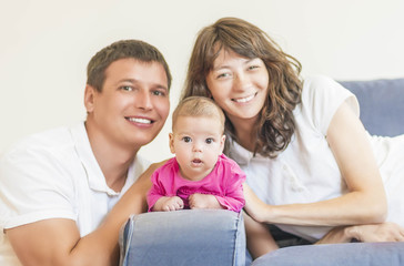 Portrait of Caucasian Family of Three People Sitting Together. P