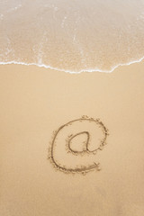 Fototapeta na wymiar Email symbol draw on beach