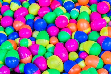 Colorful plastic eggs toys floating on the water background