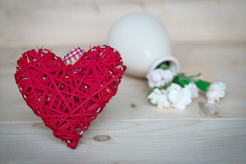 heart on the wooden background with flowers