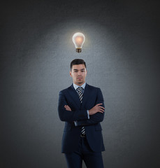 Business man with idea light bulb above head