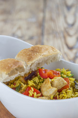 Bowl with curry flavored rice chicken and vegetables
