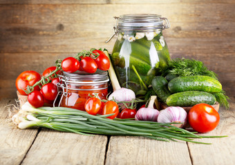 preserved tomatoes and cucumbers with fresh vegetables