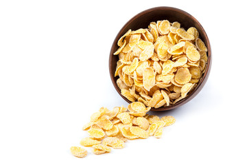 Cornflakes in a wooden bowl on white background.