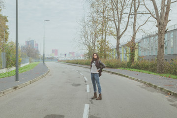 Beautiful young brunette posing in the city streets