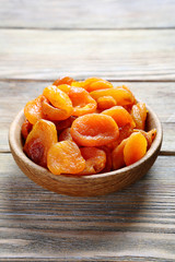 Dried apricots in a bowl on the boards
