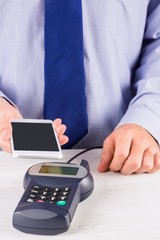 Man using smartphone to express pay