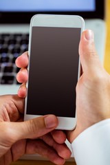 Man using laptop and smartphone