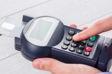 Man entering his pin on terminal